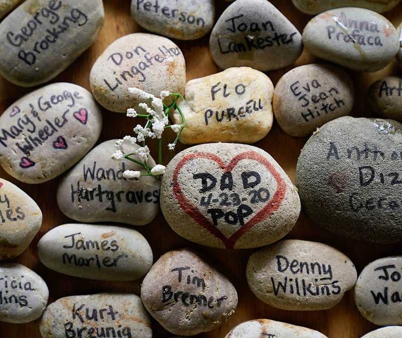 Stones with the names of various loved ones written on them.